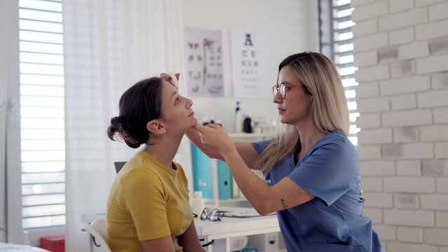 Title: Doctor examining lymp nodes on neck of the teenage girl. Palpation of lymph nodes. Concept of preventive health care for adolescents.
