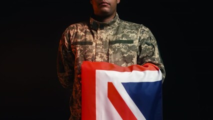 Close-up of professional military holding flag of United Kingdom, patriotism - Powered by Adobe
