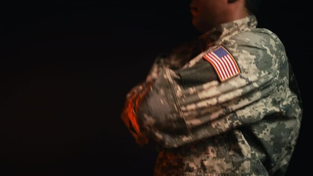 African American soldier in uniform with U.S. flag patch folding hands, honor