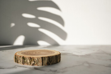 Wooden cut podium with monstera leaf shadow for natural cosmetics or products presentation