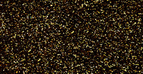 Gold glitter texture sparkling shiny background for Christmas card.  Twinkly golden  glitter lights grunge background.