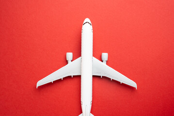 Airline plane top view on red background. Passenger transportation. Business and tourism. Airline....
