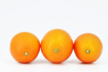 Fresh kumquat fruits, white background