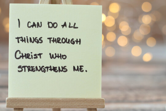 I can do all things through Christ who strengthens me, handwritten Christian quote (Philippians 4:13) with bokeh background. Close-up. Biblical concept of comfort, hope, encouragement, and strength.