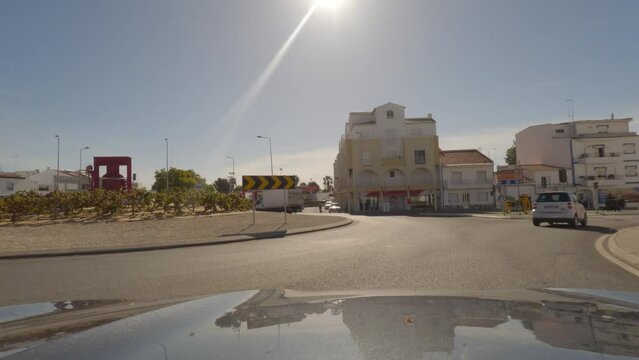 First person view, FPV, from dashcam of car driving towards the Benagil Caves, Algarve Coast, Portugal. Road trip video in POV, with blue sky on a bright sunny day
