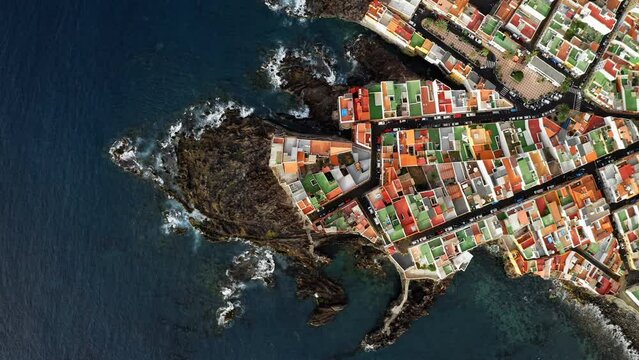 Aerial of colorful houses on a rock over ocean. Punta Brava, Tenerife, Canary islands