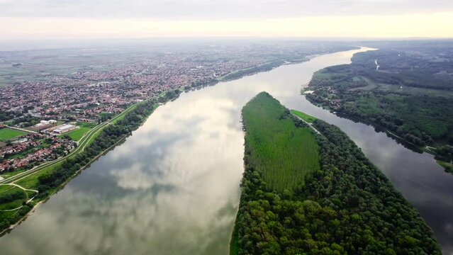 Aerial footage of Serbian town Beocin on riverbank of Danube river