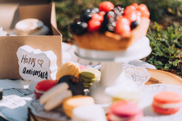 Happy Anniversary Sign With Desserts at Picnic Celebration