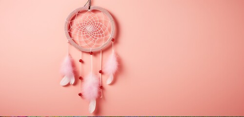 A captivating red heart-shaped dream catcher hanging gracefully against a pastel pink wall, symbolizing love and positive energy. - obrazy, fototapety, plakaty