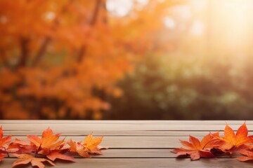Naklejka na ściany i meble Wooden Table With Orange Leaves And Blurred Autumn Background