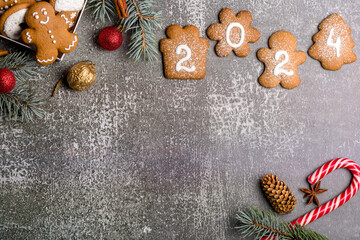 Gingerbread cookies of the form of numbers and 2024. Christmas composition with gingerbread on gray background. Copy space. Flat lay