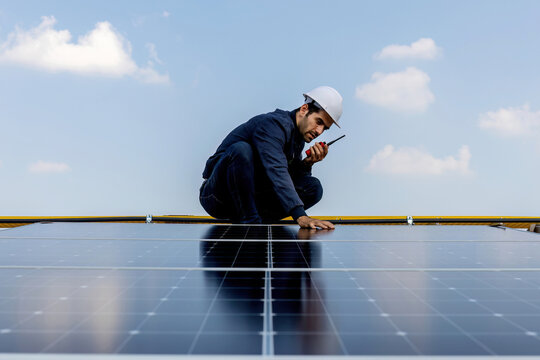 Engineer working setup Solar panel at the roof top. Engineer or worker work on solar panels or solar cells on the roof of business building