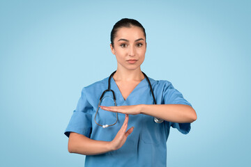 Woman medical professional with time out hand signal