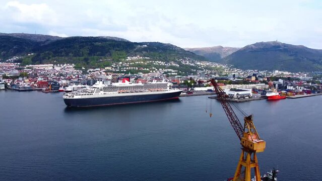 Cruise Ship Queen Mary 2 with Yellow Crane in Bergen Harbor - Norway 2.7K Aerial Footage