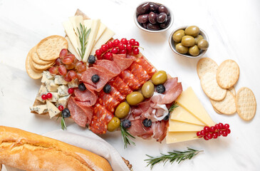 Party charcuterie board prosciutto ham, salami and cheese appetizers served in the shape of a Christmas tree. party food for New Year's Eve, Christmas or birthday