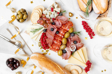 Party charcuterie board prosciutto ham, salami and cheese appetizers served in the shape of a...