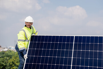 Service engineer installing solar cell on the roof of factory. Technicians working about solar panel system outdoors. Clean and Renewable energy concept.