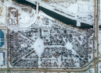 Small park with bare trees covered with snow. Aerial view to winter park in Yekaterinburg