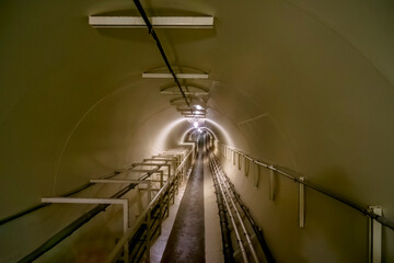 An underground utility access tunnel between buildings