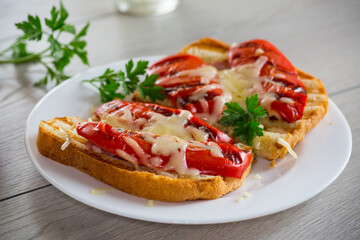 hot sandwich of fried toast bread with baked peppers and cheese