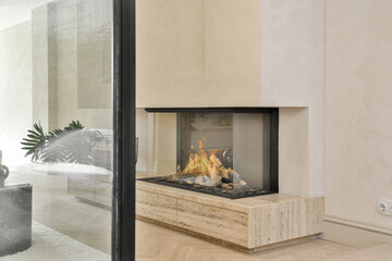 Firewood burning inside glass covered fireplace