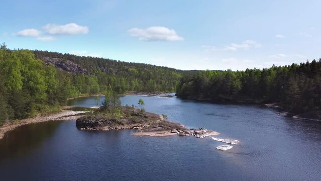 Small Rocky Island with Trees in Norwegian River - Grovane, Norway - 2.7K Aerial Footage