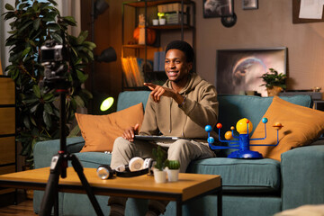 African blogger shares her scientific knowledge with the world from her home studio, surrounded by lab equipment and high-tech gear.