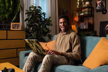 First job experience young guy student wearing wireless headset earphones working online in call center support hotline mature positive agent during conversation looking at camera.