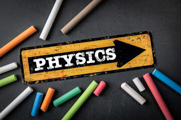 PHYSICS. Direction arrow with text on a dark chalkboard background