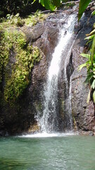 La cascade tombe devant les rochers