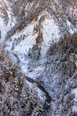 Top view of winter river in the Swiss Alps, Switzerland. Snowy mountain river landscape
