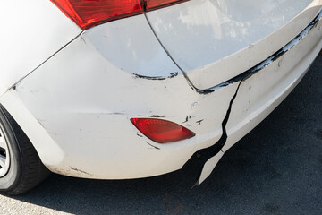 A broken damaged rear bumper on a car, damage often encountered in road accidents. - obrazy, fototapety, plakaty