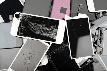 A heap with the broken screens lying one on top of another. Devices are prepared for utilization