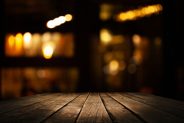 Empty dark wooden table in front of restaurant abstract blurred bokeh background. can be used to...