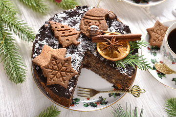Top view of Christmas pastry called Japanese poppy seed cake decorated with gingerbread cookies