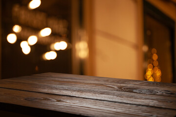 Empty dark wooden table in front of restaurant abstract blurred bokeh background. can be used to demonstrate or mount your products. Layout for space