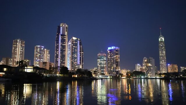 Twilight timelapse cityscape of Australian skyline reflecting on water
