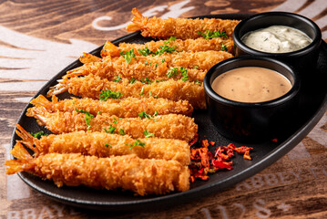 crispy shrimp tempura with garlic sauce on plate