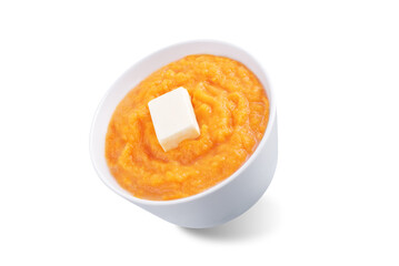 Cooked sweet potato puree in a bowl on a white isolated background
