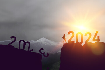 Loading year 2024. Successful lucky man to the top of the mountain from 2024 year number. Business start up or goal to success. High quality photo - obrazy, fototapety, plakaty