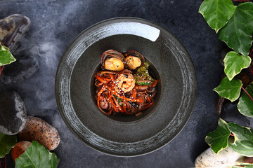 Brown soba noodles with seafood and sesame seeds. Broccoli, tiger prawns and large mussels with noodles. Teriyaki sauce.Flat lay. Top view. Copy space.Asian cuisine.