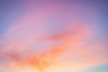 Majestic dusk. Sunset sky twilight in the evening with colorful sunlight. Bright colors. Abstract nature background. Moody pink, purple, orange and yellow clouds sunset sky.