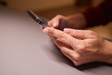 Young woman using apps on a mobile touchscreen smartphone. Concept for using technology, shopping online, mobile apps, texting, addiction, swipe up, swipe down.