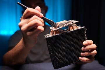 Cleaning a processor fan with a brush