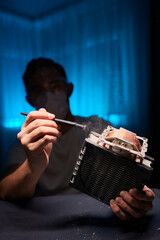 Cleaning a processor fan with a brush