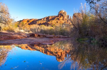 Cathedral Rock Sandstone Formation Reflected in Oak Creek Calm Water.  Scenic Red Rocks State Park Autumn Landscape, Sedona Arizona Southwest USA