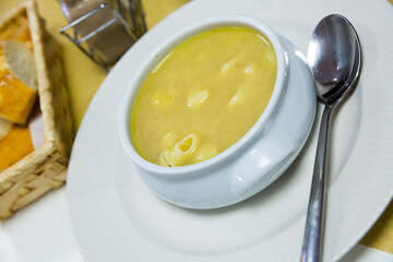 Bowl of tasty pasta bouillon served in white bowl