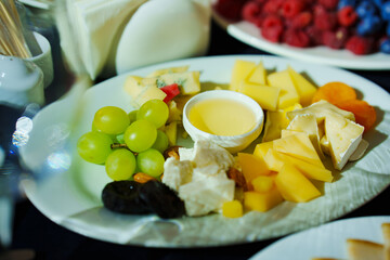 Banquet table with black tablecloth served with appetizers. 