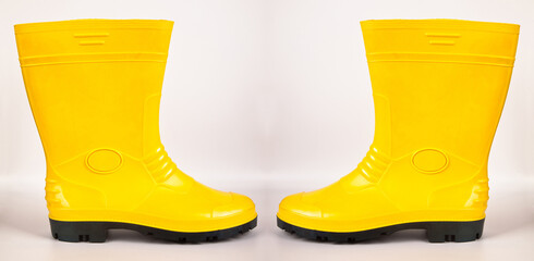 Waterproof yellow rubber boots isolated on white background