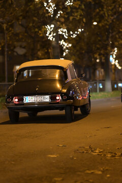 Backside of an old black Citroen DS classic car on the road at night in Duesseldorf, Germany.